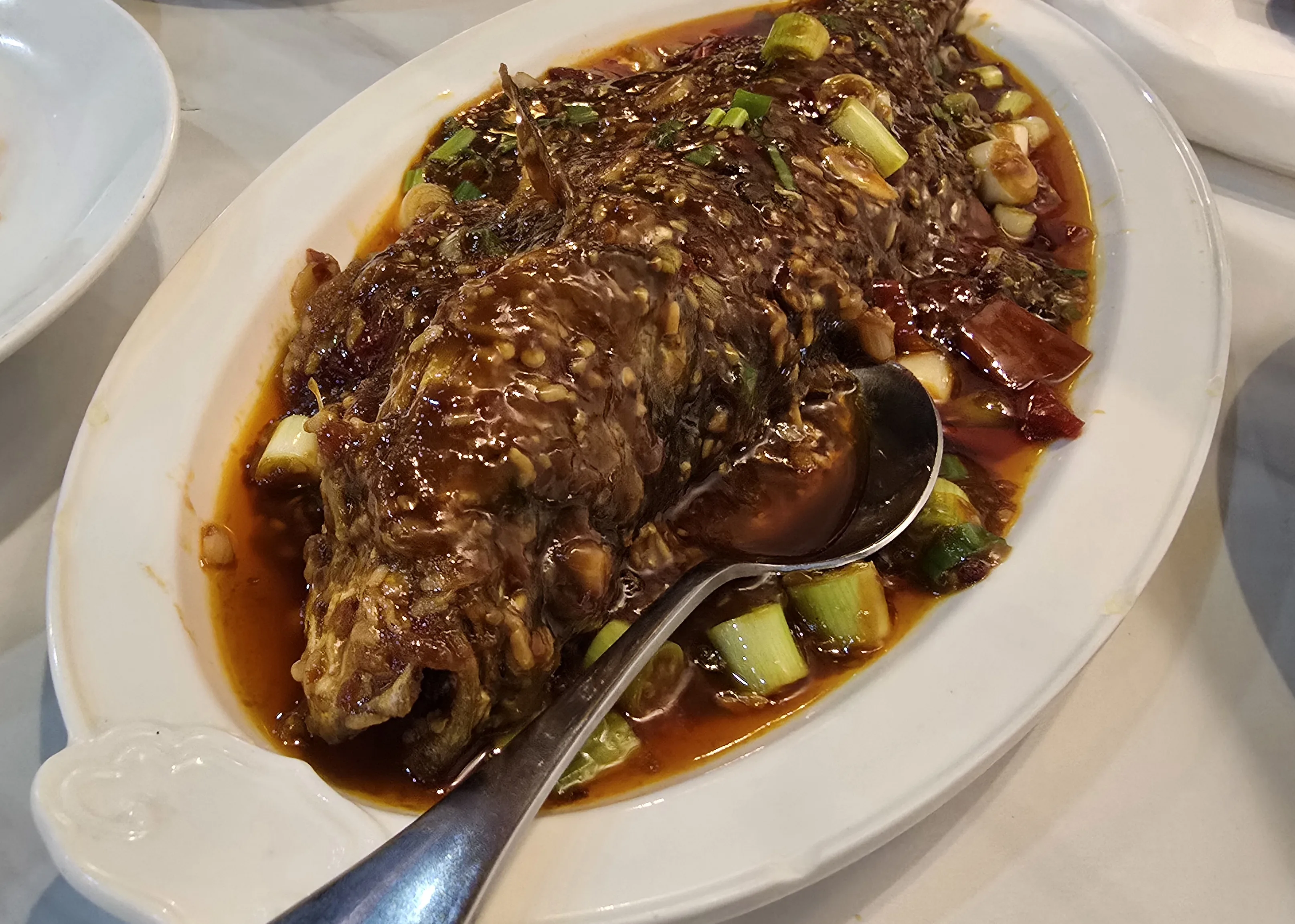 Poached whole fish in tangy pickled chili sauce at Chef Yan